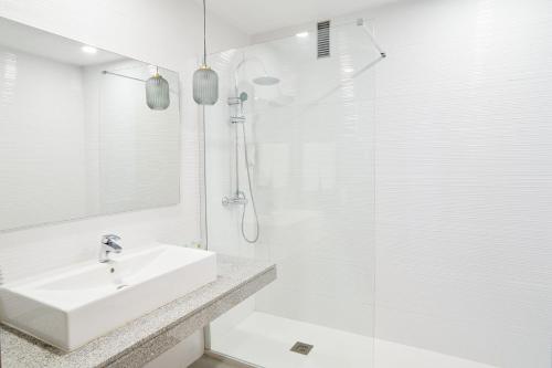 a white bathroom with a sink and a shower at Hotel Torre Del Conde in San Sebastián de la Gomera
