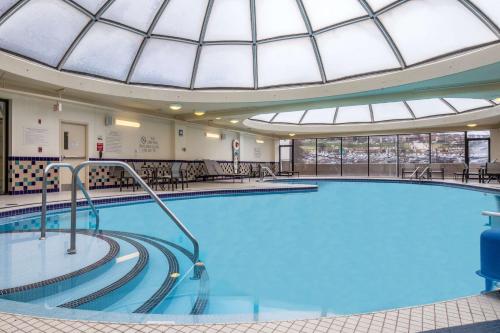 a large swimming pool in a building with a domed ceiling at DoubleTree by Hilton Hotel & Suites Pittsburgh Downtown in Pittsburgh