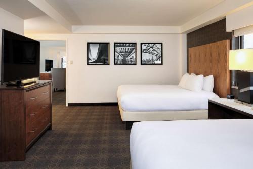 a hotel room with two beds and a flat screen tv at DoubleTree by Hilton Hotel & Suites Pittsburgh Downtown in Pittsburgh