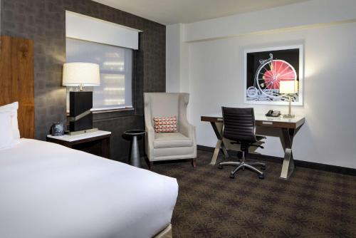 a hotel room with a bed and a desk and chair at DoubleTree by Hilton Hotel & Suites Pittsburgh Downtown in Pittsburgh