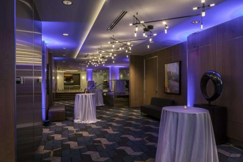 a room with two tables and purple lighting at DoubleTree by Hilton Hotel & Suites Pittsburgh Downtown in Pittsburgh