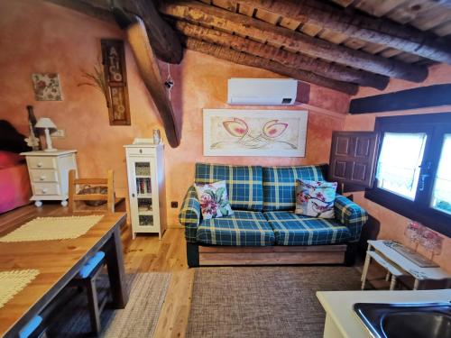 a living room with a couch and a sink at Ático Pirón in Adrada de Pirón