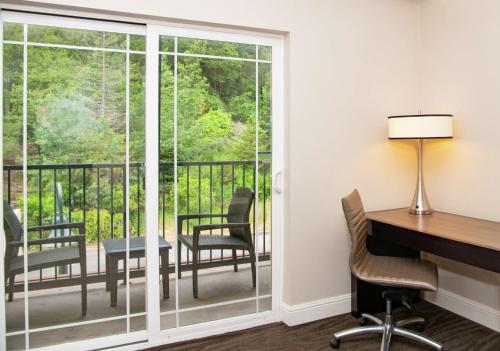 an office with a desk and a computer and a balcony at Hilton Santa Cruz Scotts Valley in Santa Cruz