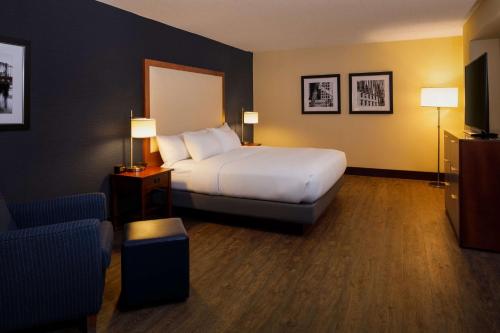 a hotel room with a bed and a chair at DoubleTree by Hilton Pittsburgh - Cranberry in Cranberry Township