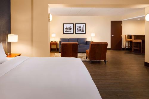 a hotel room with a bed and a living room at DoubleTree by Hilton Pittsburgh - Cranberry in Cranberry Township