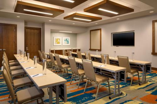 a conference room with tables and chairs and a flat screen tv at DoubleTree by Hilton Pittsburgh - Cranberry in Cranberry Township