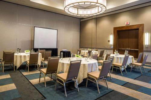 a conference room with tables and chairs and a projection screen at DoubleTree by Hilton Pittsburgh - Cranberry in Cranberry Township