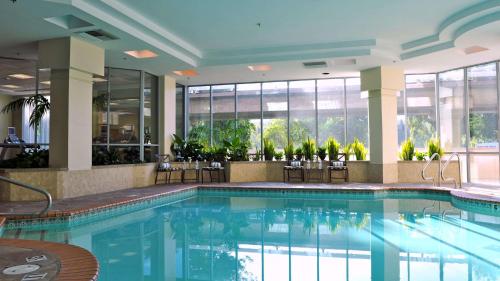 a large swimming pool in a hotel lobby at Embassy Suites by Hilton Walnut Creek in Walnut Creek