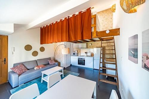 a living room and kitchen with a couch and a table at Le Cocoon-4pers avec mezzanine-Cusset Villeurbanne in Villeurbanne