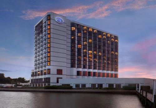 a building with a clock on the side of it at Hilton Houston NASA Clear Lake in Seabrook