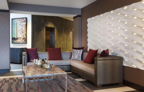 a living room with a couch and a table at Embassy Suites by Hilton Dulles Airport in Herndon