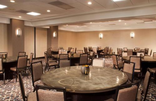 a conference room with a large table and chairs at Embassy Suites by Hilton Dulles Airport in Herndon
