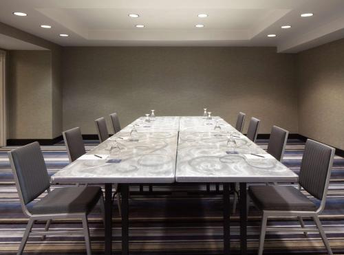 a long table in a conference room with chairs at Hilton Houston NASA Clear Lake in Seabrook