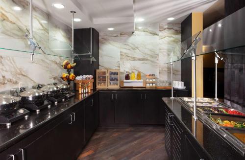 a kitchen with black counters and marble walls at DoubleTree by Hilton El Paso Downtown in El Paso
