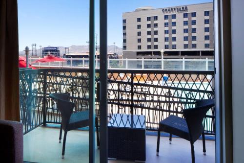 a balcony with chairs and a view of a building at DoubleTree by Hilton El Paso Downtown in El Paso