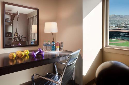 a desk in a hotel room with a mirror at DoubleTree by Hilton El Paso Downtown in El Paso