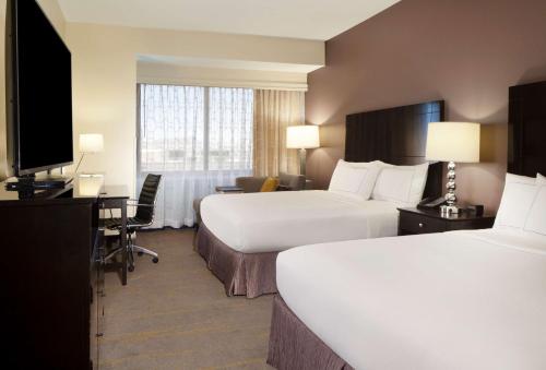a hotel room with two beds and a television at DoubleTree by Hilton El Paso Downtown in El Paso