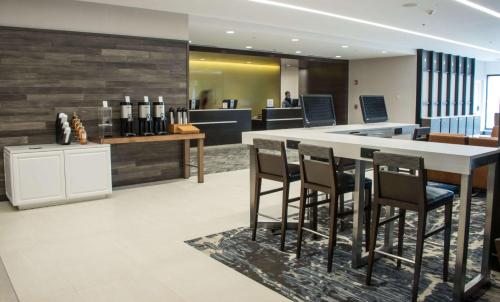 a lobby with a table and chairs in a building at DoubleTree by Hilton Hotel Syracuse in East Syracuse