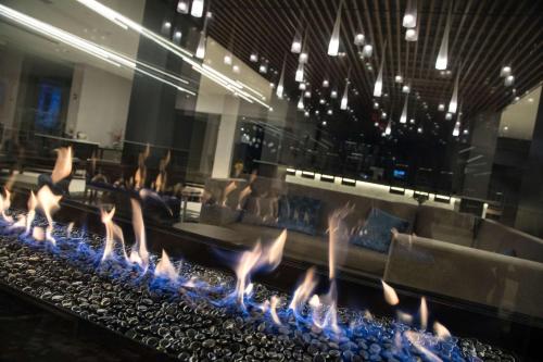 a fire pit with blue flames in a restaurant at DoubleTree by Hilton Hotel Syracuse in East Syracuse