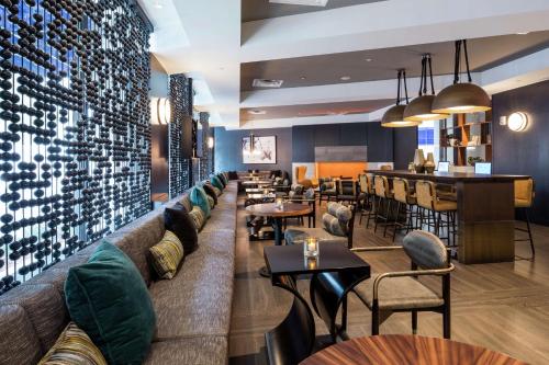 a restaurant with a couch and tables and a bar at Hilton Boston Back Bay in Boston