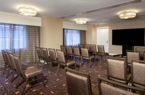 a conference room with chairs and a flat screen tv at Hilton Boston Back Bay in Boston