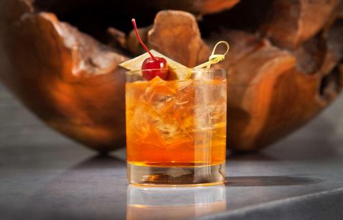 a drink with a cherry on a table at Hilton Boston Back Bay in Boston