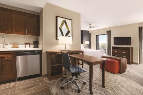 a kitchen and living room with a desk and a bed at Homewood Suites by Hilton Washington DC Capitol-Navy Yard in Washington