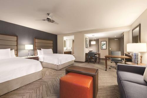 a hotel room with two beds and a couch at Homewood Suites by Hilton Washington DC Capitol-Navy Yard in Washington