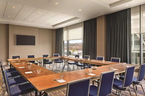 a conference room with tables and chairs and a screen at Homewood Suites by Hilton Washington DC Capitol-Navy Yard in Washington