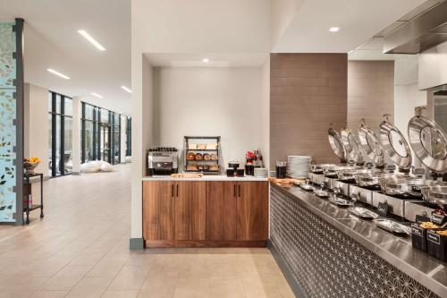 a large kitchen with a counter in a restaurant at Hilton Garden Inn Boulder in Boulder