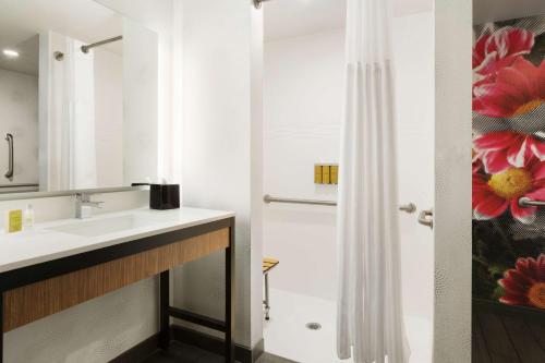a bathroom with a sink and a shower at Hilton Garden Inn Boulder in Boulder
