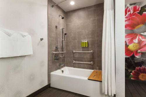a bathroom with a white tub and a shower at Hilton Garden Inn Boulder in Boulder