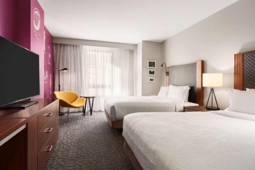 um quarto de hotel com duas camas e uma televisão de ecrã plano em Hilton Garden Inn Boulder em Boulder