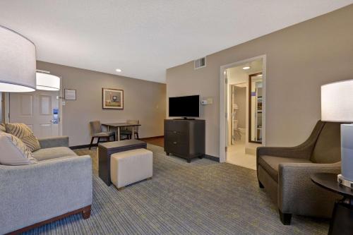 a living room with a couch and a tv at Homewood Suites by Hilton Boulder in Boulder