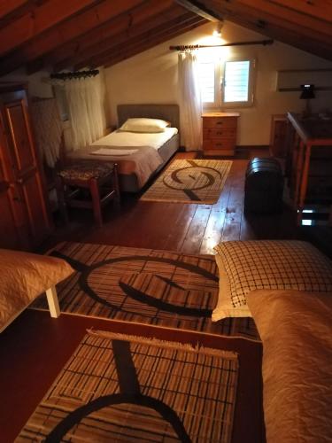 a bedroom with two beds and a table in a room at SAMOS 1880 in Marathokampos