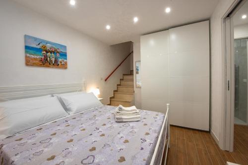 En eller flere senge i et værelse på VF casa vacanze