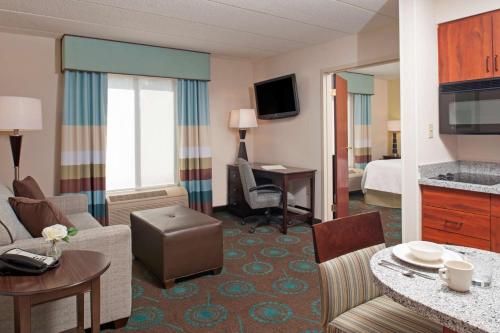 a hotel room with a bedroom and a living room at Hampton Inn & Suites Kokomo in Kokomo