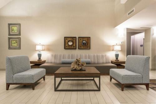 a living room with a couch and two chairs and a table at Hampton Inn Morehead City in Morehead City
