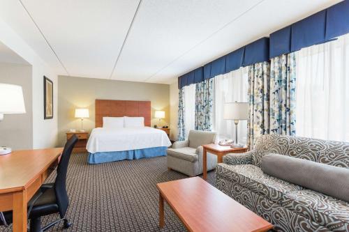 a hotel room with a bed and a desk at Hampton Inn Morehead City in Morehead City