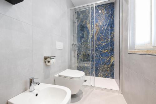 a bathroom with a toilet and a sink and a shower at Hotel Arya by Mauro in Sirmione