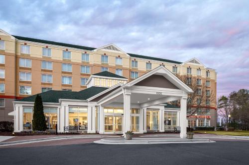 a hotel with a large building with a gazebo at Hilton Garden Inn Raleigh Durham Airport in Morrisville