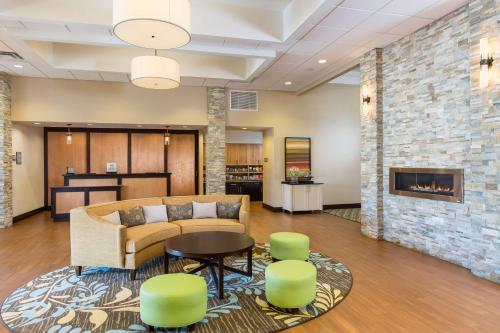 a lobby with a couch and chairs and a fireplace at Homewood Suites by Hilton San Bernardino in San Bernardino