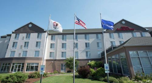 a hotel with three flags in front of it at Hilton Garden Inn Springfield, IL in Springfield