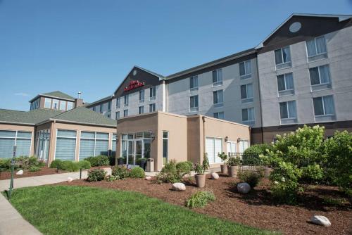 a hotel building with a garden in front of it at Hilton Garden Inn Springfield, IL in Springfield