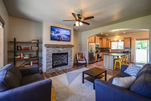 a living room with two couches and a fireplace at CDA Hideaway 4 bed 3 Bath Modern Mid Term Rental in Hayden