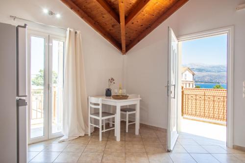 a room with a table and a large window at Your Destination in Lixouri