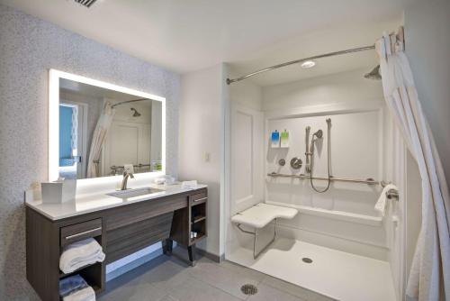 a bathroom with a sink and a tub and a shower at Home2 Suites by Hilton Perrysburg Levis Commons Toledo in Perrysburg