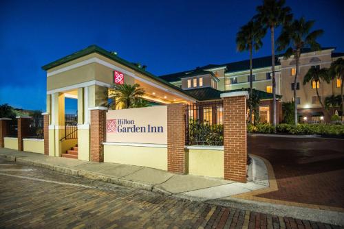 a hotel with a sign in front of a building at Hilton Garden Inn Tampa Ybor Historic District in Tampa