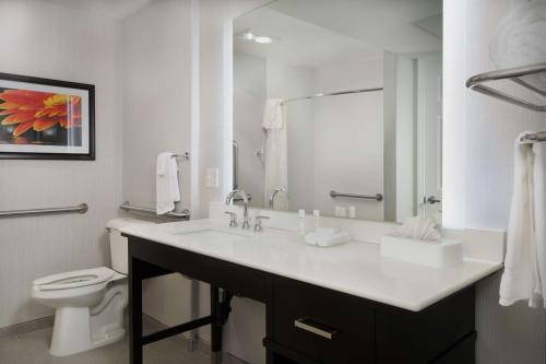 a white bathroom with a sink and a toilet at Homewood Suites by Hilton Vancouver / Portland in Vancouver