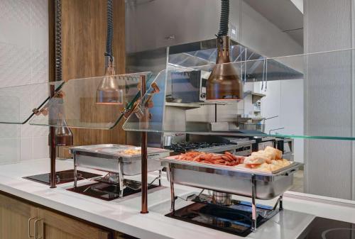 a kitchen with some food on a counter at Hilton Garden Inn Madison Huntsville Airport in Madison